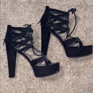 Black suede-like platform high heel.